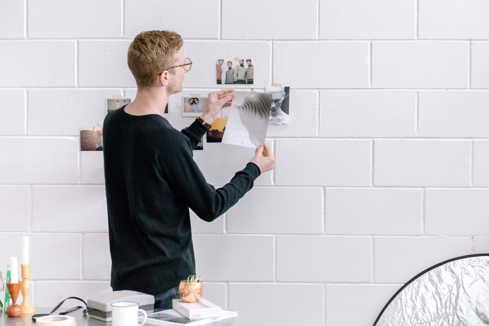 Photo by Bench Accounting man holding paper infront by wall