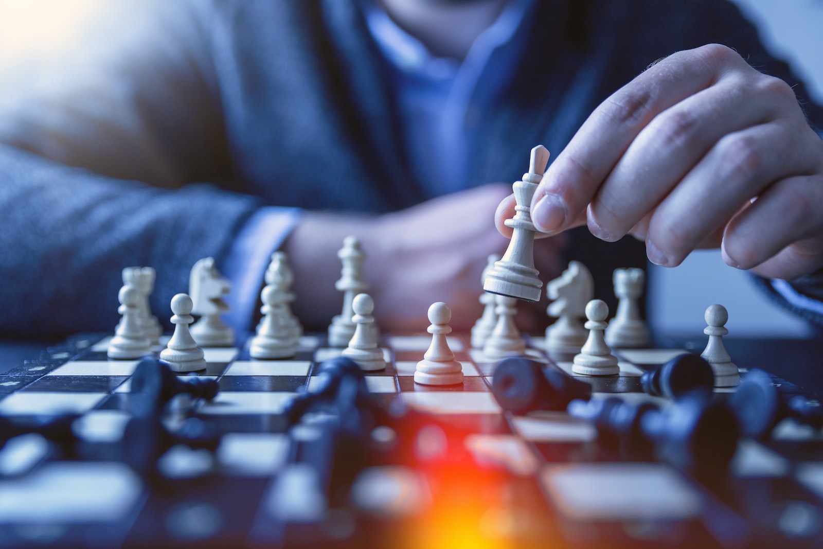 Photo by JESHOOTS.COM depth of field photography of man playing chess