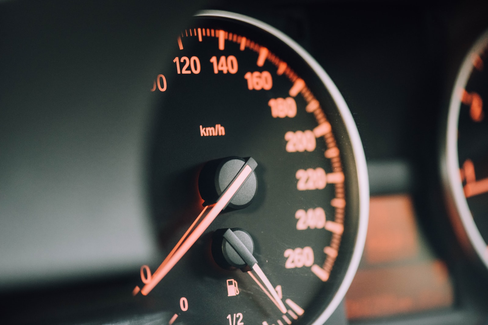 Photo by CHUTTERSNAP closeup photo of black analog speedometer
